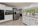 Spacious kitchen with white cabinets, stainless steel appliances, and an island at 1172 Malvern Hunt Ct, Lawrenceville, GA 30043