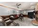 Spacious living room with stone fireplace, ceiling fans, and plush leather seating at 1172 Malvern Hunt Ct, Lawrenceville, GA 30043