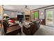 Cozy living room features a stone fireplace, ceiling fans, and a comfortable seating area at 1172 Malvern Hunt Ct, Lawrenceville, GA 30043
