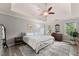 Calm main bedroom featuring tray ceilings, neutral walls, and a soft color palette at 1172 Malvern Hunt Ct, Lawrenceville, GA 30043