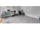 Bright home office with stylish gray floors and ample space for desk and exercise equipment at 1172 Malvern Hunt Ct, Lawrenceville, GA 30043