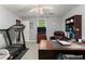 Functional office space with desk, shelving, and treadmill, perfect for a productive work-life balance at 1172 Malvern Hunt Ct, Lawrenceville, GA 30043