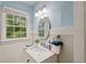 Bathroom featuring wainscoting, soft blue walls, and a modern vanity at 131 Lively St, Norcross, GA 30071