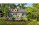 Charming home with a welcoming yellow front door, well-maintained lawn and mature landscaping at 131 Lively St, Norcross, GA 30071