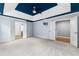 Spacious bedroom boasting a blue tray ceiling, plush carpet, and multiple entryways for an open feel at 1310 Scenic View Trce, Lawrenceville, GA 30044