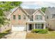 Charming two-story brick home with a well-manicured lawn, attached garage, and inviting front porch at 1310 Scenic View Trce, Lawrenceville, GA 30044