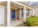 Charming entryway with a blue front door, brick facade, and manicured landscaping, enhancing curb appeal at 1310 Scenic View Trce, Lawrenceville, GA 30044