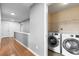 Hallway leading to a laundry room with modern front-loading machines at 1310 Scenic View Trce, Lawrenceville, GA 30044