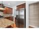 Kitchen with stainless steel fridge, granite counters, and wooden cabinets at 1310 Scenic View Trce, Lawrenceville, GA 30044