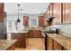 Kitchen featuring granite countertops, stainless appliances, an island, and wooden cabinets at 1310 Scenic View Trce, Lawrenceville, GA 30044