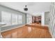 Living room featuring an open floor plan with hardwood floors adjacent to the kitchen at 1310 Scenic View Trce, Lawrenceville, GA 30044