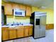 Finished basement kitchenette with wood cabinets, stainless steel appliances and sink at 4503 Hunters Ter, Stone Mountain, GA 30083
