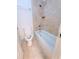 Bathroom featuring a tub and shower with a tile wall and toilet at 4503 Hunters Ter, Stone Mountain, GA 30083