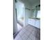 Bright bathroom featuring a soaking tub, white vanity, and neutral tile flooring at 4503 Hunters Ter, Stone Mountain, GA 30083