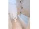 Bathroom featuring a tub and shower with a tile wall and toilet at 4503 Hunters Ter, Stone Mountain, GA 30083