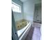 Bathroom with a jacuzzi tub, tile flooring, and a window offering natural light at 4503 Hunters Ter, Stone Mountain, GA 30083