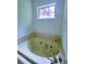 Bright bathroom highlighting a soaking tub with window and tile surround at 4503 Hunters Ter, Stone Mountain, GA 30083