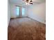 Spacious bedroom with neutral carpet, ceiling fan, and window at 4503 Hunters Ter, Stone Mountain, GA 30083