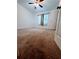 Spacious bedroom featuring neutral carpet, a window with curtains, and a ceiling fan at 4503 Hunters Ter, Stone Mountain, GA 30083