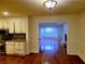 View from kitchen looking into the dining room with hardwood floors and a large window for lots of light at 4503 Hunters Ter, Stone Mountain, GA 30083