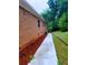 Brick home exterior featuring a walkway surrounded by fresh mulch and manicured lawn at 4503 Hunters Ter, Stone Mountain, GA 30083