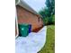 Brick home exterior featuring a walkway surrounded by fresh mulch, lawn and trash receptacles at 4503 Hunters Ter, Stone Mountain, GA 30083