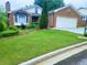 Charming brick home featuring a manicured front lawn, brick exterior, and attached two-car garage at 4503 Hunters Ter, Stone Mountain, GA 30083