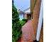 A red brick walkway leads to the home's entrance near a manicured yard and brick exterior at 4503 Hunters Ter, Stone Mountain, GA 30083