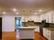 Bright kitchen with granite countertops, island, stainless steel appliances and attractive backsplash at 4503 Hunters Ter, Stone Mountain, GA 30083
