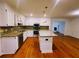 Updated kitchen featuring granite countertops, stainless appliances, and an island with pendant lighting at 4503 Hunters Ter, Stone Mountain, GA 30083