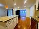 Kitchen island with granite countertop, with view into another room with large windows at 4503 Hunters Ter, Stone Mountain, GA 30083