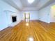 Spacious living room with hardwood floors and a fireplace featuring an open doorway to another room at 4503 Hunters Ter, Stone Mountain, GA 30083
