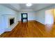 Spacious living room with hardwood floors and a fireplace featuring an open doorway to another room at 4503 Hunters Ter, Stone Mountain, GA 30083