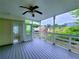 Charming covered porch with a ceiling fan, wooden deck, and views of the surrounding greenery at 4503 Hunters Ter, Stone Mountain, GA 30083
