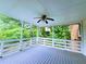 Outdoor porch with a ceiling fan, wood decking, and white railings, offering a relaxing retreat at 4503 Hunters Ter, Stone Mountain, GA 30083
