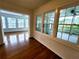 Cozy sunroom with hardwood floors and lots of windows and light, leading to an outdoor balcony at 4503 Hunters Ter, Stone Mountain, GA 30083
