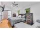 Inviting bedroom with hardwood floors, rustic furniture, natural light, and a sliding barn door leading to the en-suite at 1497 Eason Nw St, Atlanta, GA 30314