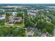 Aerial view of neighborhood with a picture of the home over it and trees surrounding the properties at 2100 Rockies Ct, Norcross, GA 30071