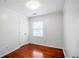 Cozy bedroom featuring hardwood floors, a window for natural light, and a closet for storage at 2100 Rockies Ct, Norcross, GA 30071