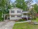 Two story home featuring neutral siding, red shutters and a well maintained lawn at 2100 Rockies Ct, Norcross, GA 30071