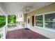 Inviting front porch with white railings, a dark wood floor, and views of the yard at 2100 Rockies Ct, Norcross, GA 30071