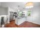Well-lit kitchen featuring stainless steel appliances, gray countertops, and convenient access to the backyard at 2100 Rockies Ct, Norcross, GA 30071