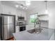 Updated kitchen featuring stainless steel appliances, shaker cabinets, modern light fixtures, and backsplash at 2100 Rockies Ct, Norcross, GA 30071
