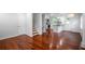 Open-concept living space with hardwood floors connecting the living room, kitchen, and staircase at 2100 Rockies Ct, Norcross, GA 30071