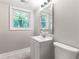Well-lit bathroom featuring a sleek mirror and natural light from the window at 3017 Tribble Ln, Atlanta, GA 30311