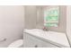 Bathroom with vanity, modern fixtures, and serene view from window at 3017 Tribble Ln, Atlanta, GA 30311