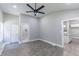 Bright bedroom featuring wood-look floors, ceiling fan, and an ensuite bathroom for a relaxing retreat at 3017 Tribble Ln, Atlanta, GA 30311