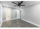 Bright bedroom with modern gray walls, updated floors, two closets, an en suite bathroom, and recessed lighting at 3017 Tribble Ln, Atlanta, GA 30311