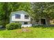 Charming home featuring a well-manicured lawn, classic white siding, black trim windows, and a cozy, inviting front porch at 3017 Tribble Ln, Atlanta, GA 30311