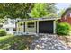Lovely home featuring a classic exterior, a cozy front porch, and an attached garage with painted brickwork at 3017 Tribble Ln, Atlanta, GA 30311
